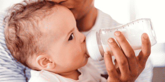bottle feeding a baby