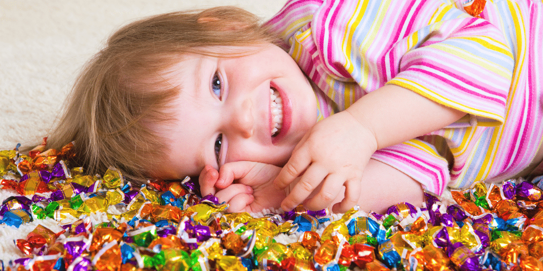 kid laying in candy