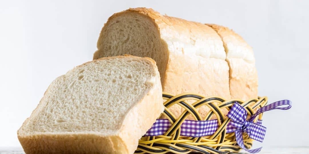 bread in a bag served in a basket, sliced