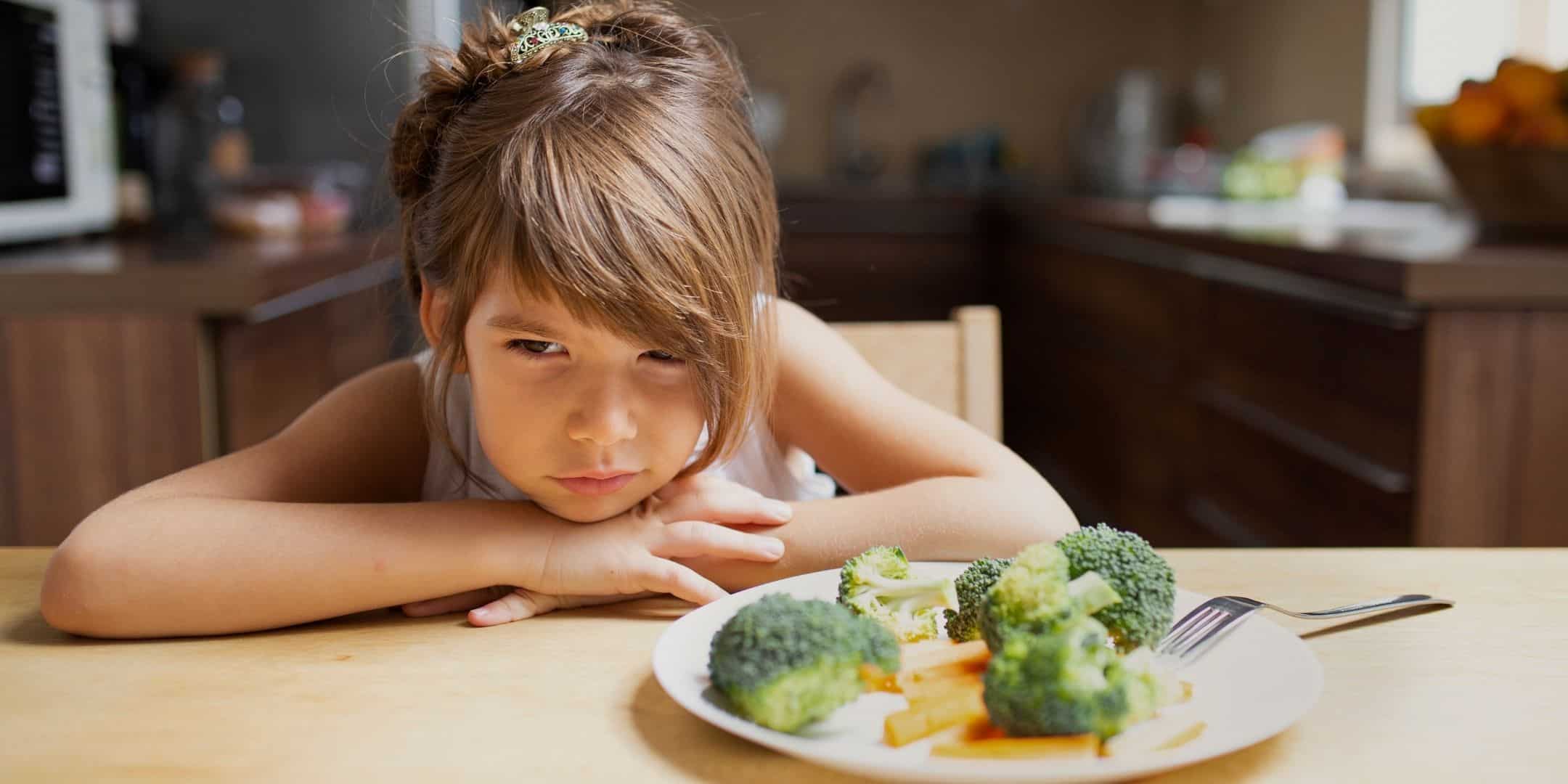 picky eater staring at plate of food untouched