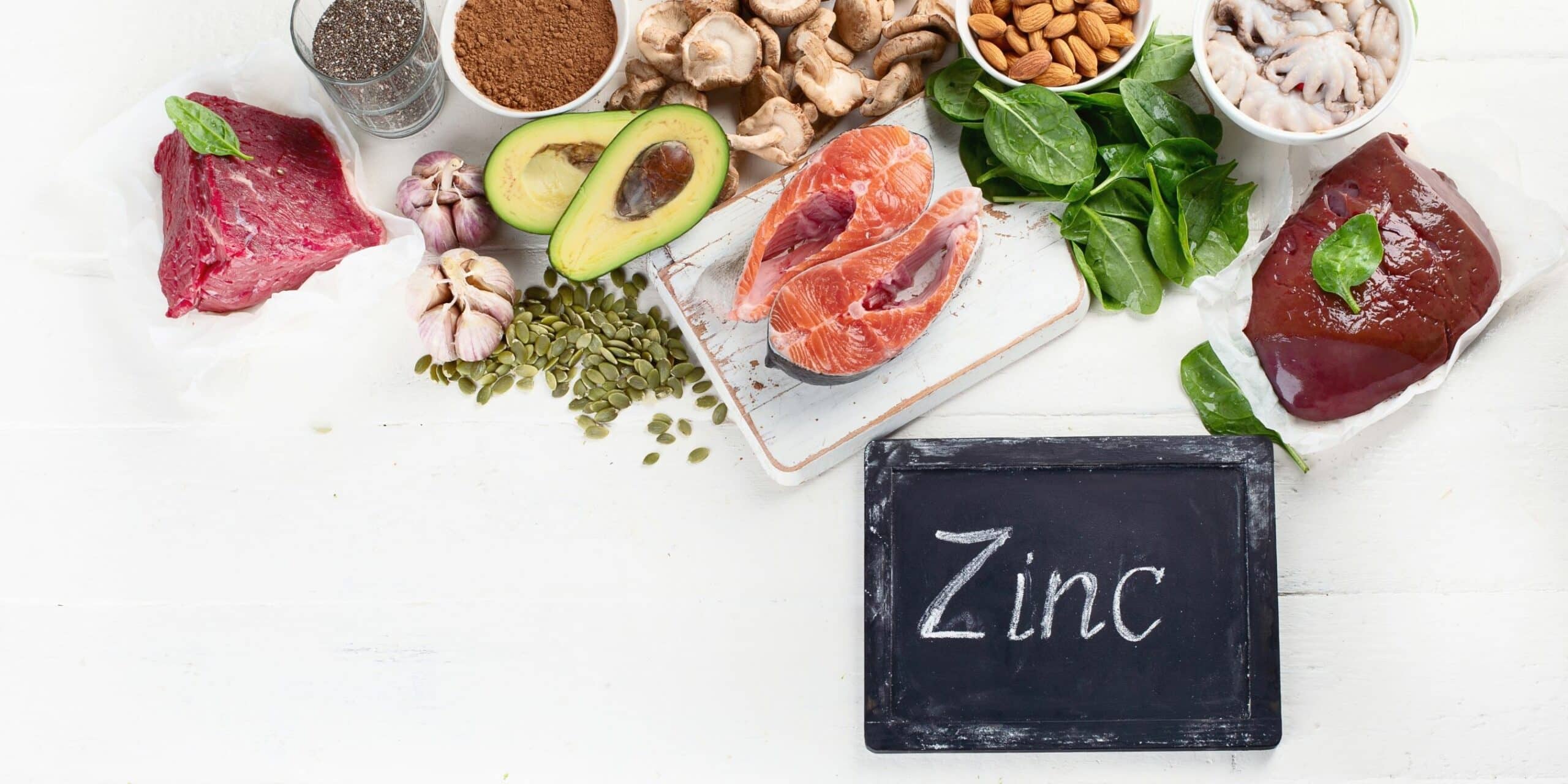 zinc written on chalkboard with zinc containing foods surrounding it