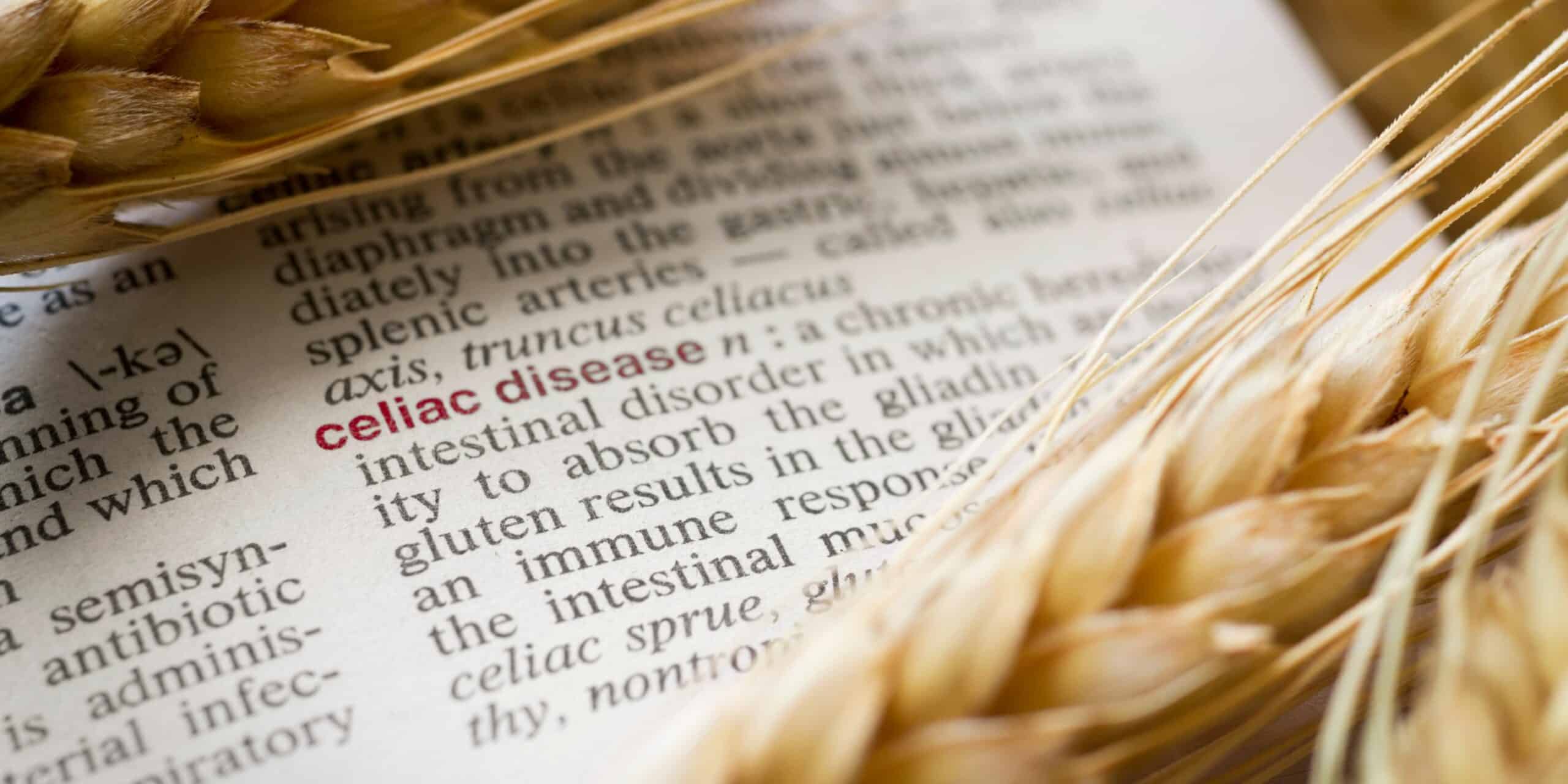 pieces of wheat over a page in a dictionary around the word celiac disease and its definition