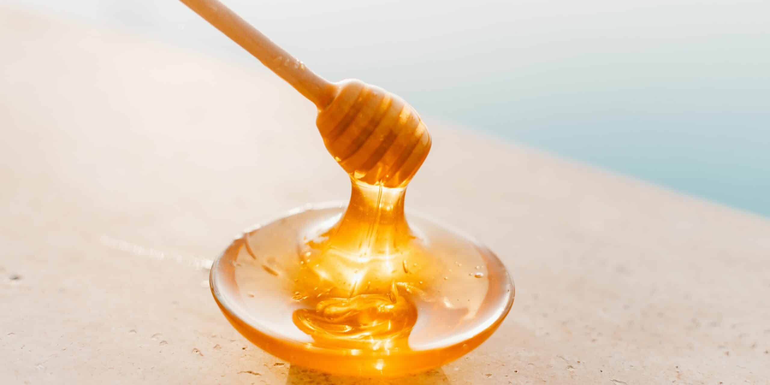 honey being dripped into a bowl